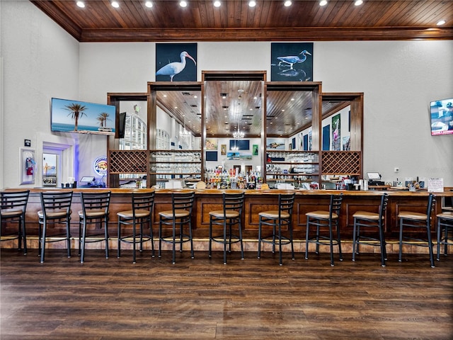 bar featuring crown molding, dark wood-type flooring, and wood ceiling