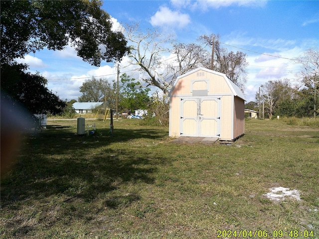 view of outbuilding featuring a yard