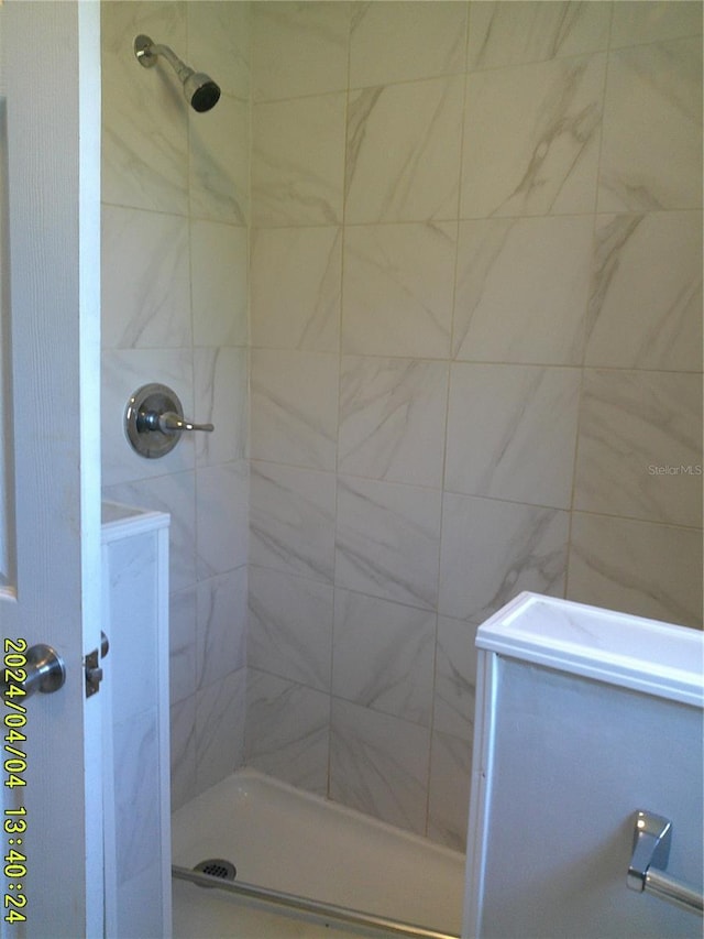 bathroom with tiled shower