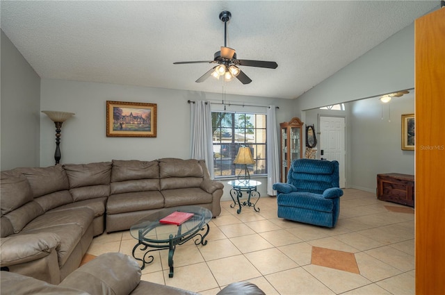 tiled living room featuring a textured ceiling, vaulted ceiling, and ceiling fan