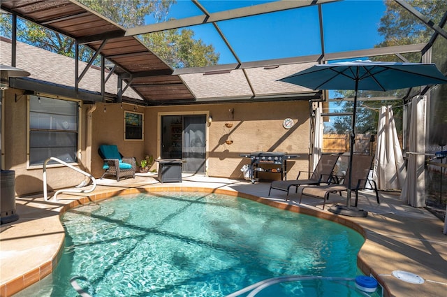 view of pool with a patio and glass enclosure