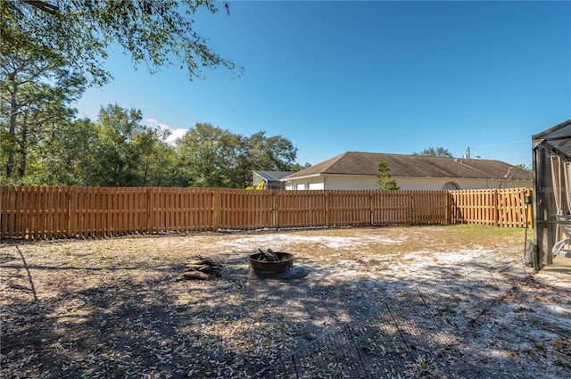 view of yard with a fire pit