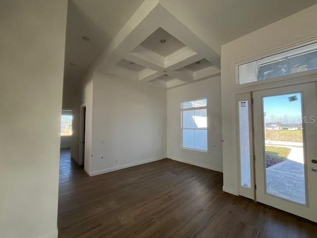 entrance foyer featuring dark wood-style floors, coffered ceiling, baseboards, and a healthy amount of sunlight