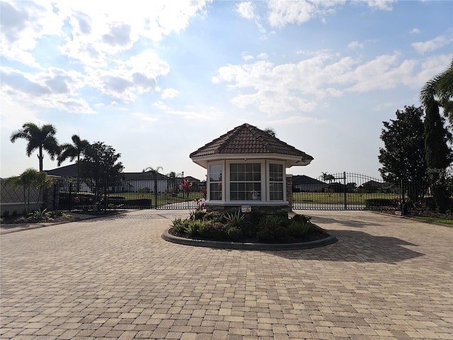 view of home's community with a gate and fence