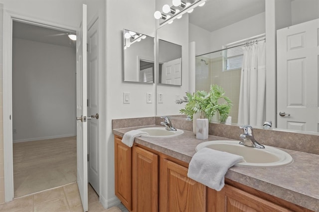 bathroom with a shower with curtain, tile patterned floors, and vanity