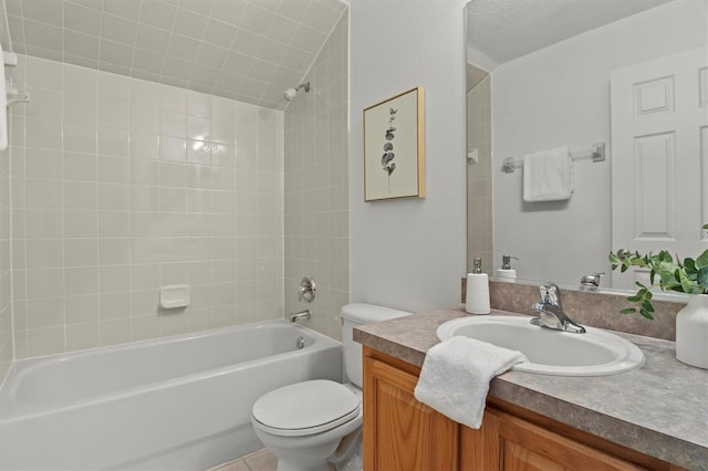 full bathroom featuring vanity, tiled shower / bath, and toilet