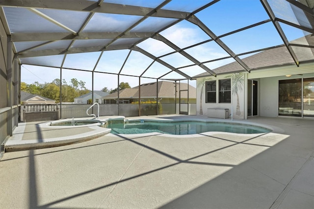 view of pool with an in ground hot tub, a patio, and glass enclosure