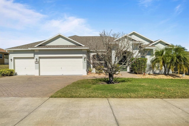 view of front of property featuring a garage and a front lawn