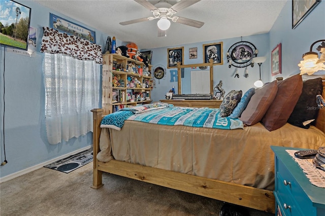 bedroom with ceiling fan, carpet, and a textured ceiling