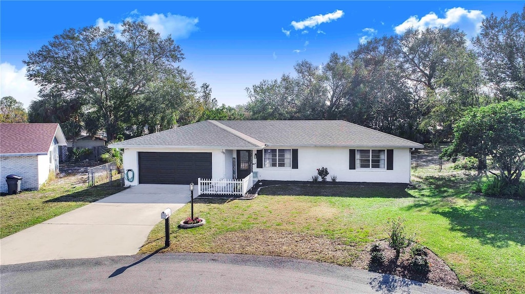 ranch-style home with a garage and a front yard