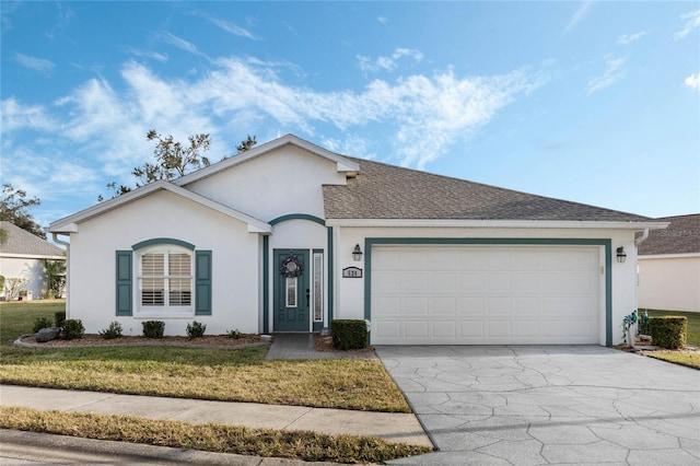 ranch-style house featuring a garage and a front lawn