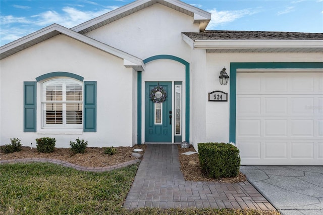 view of exterior entry featuring a garage