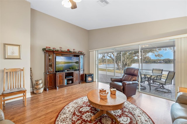 living room with hardwood / wood-style flooring and ceiling fan