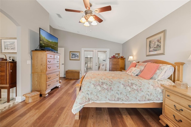 bedroom with lofted ceiling, hardwood / wood-style flooring, french doors, and ceiling fan