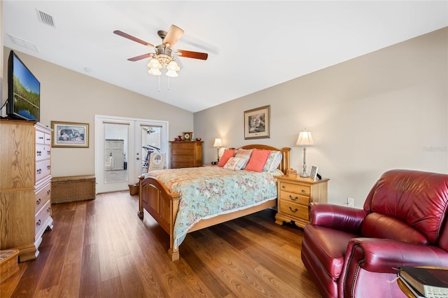 bedroom featuring french doors, dark hardwood / wood-style flooring, vaulted ceiling, and access to outside