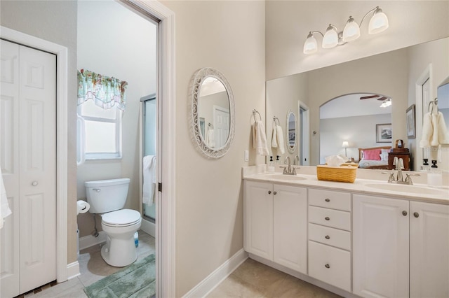 bathroom featuring vanity, walk in shower, tile patterned floors, and toilet