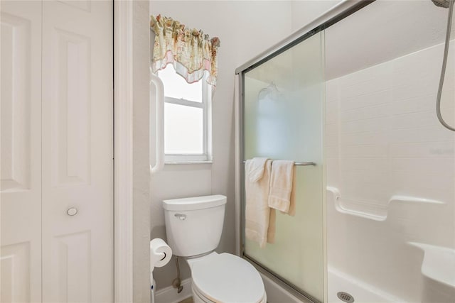 bathroom featuring an enclosed shower and toilet