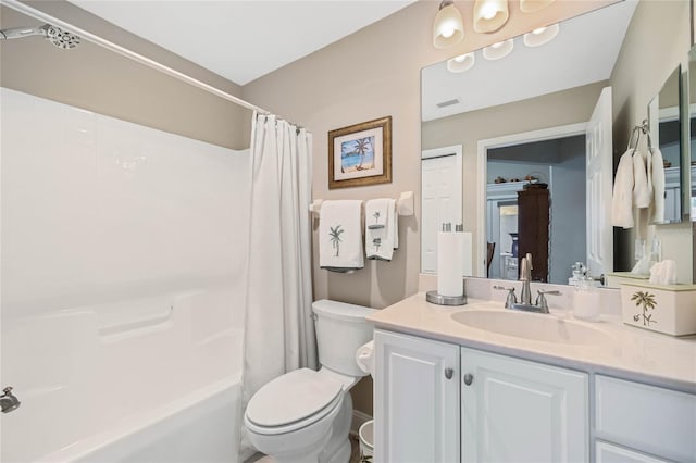 full bathroom with vanity, shower / bath combination with curtain, and toilet