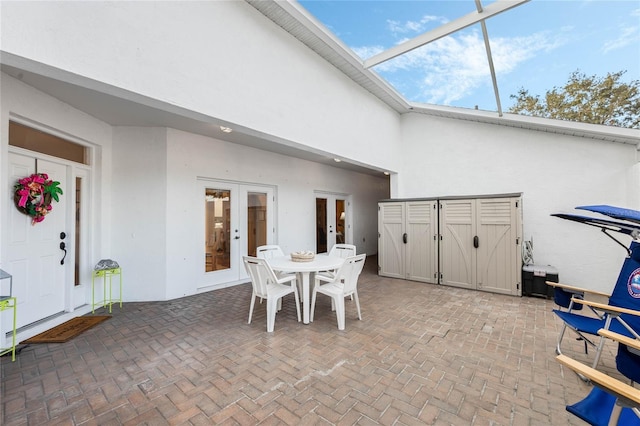 view of patio / terrace featuring french doors and glass enclosure