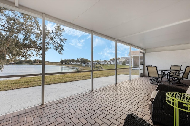 sunroom / solarium with a water view