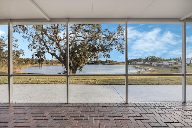 unfurnished sunroom with a water view