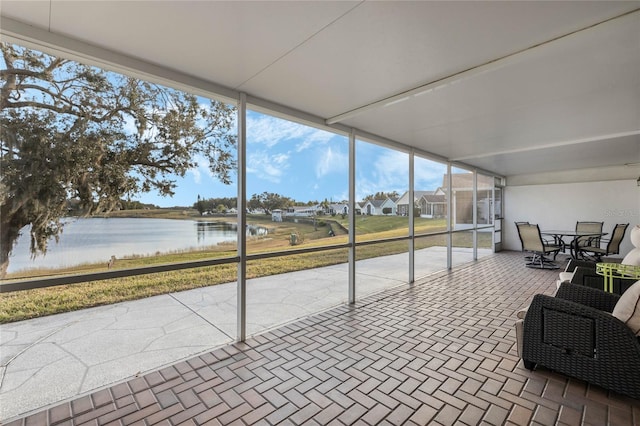 sunroom / solarium with a water view