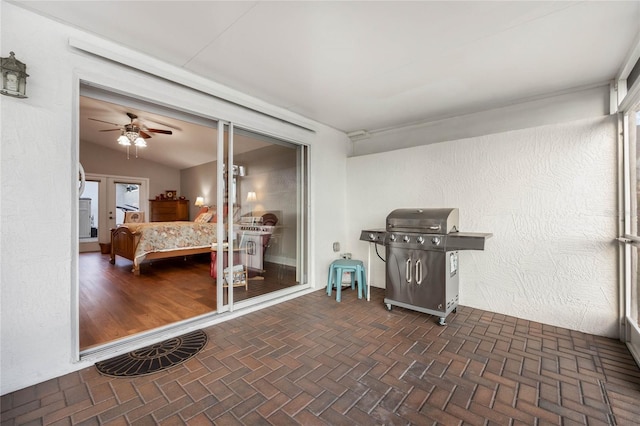 sunroom with vaulted ceiling and ceiling fan