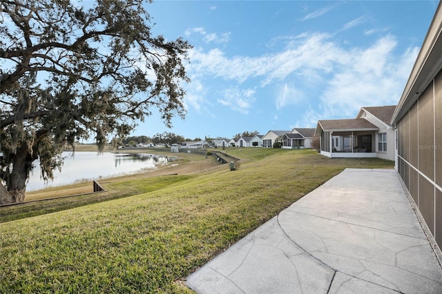 view of yard with a water view and a patio area