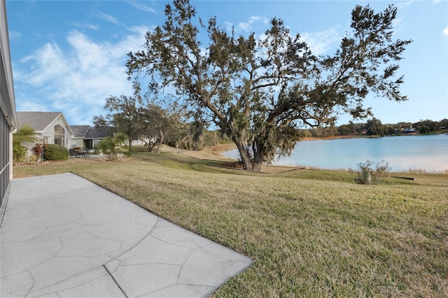 view of yard featuring a patio and a water view