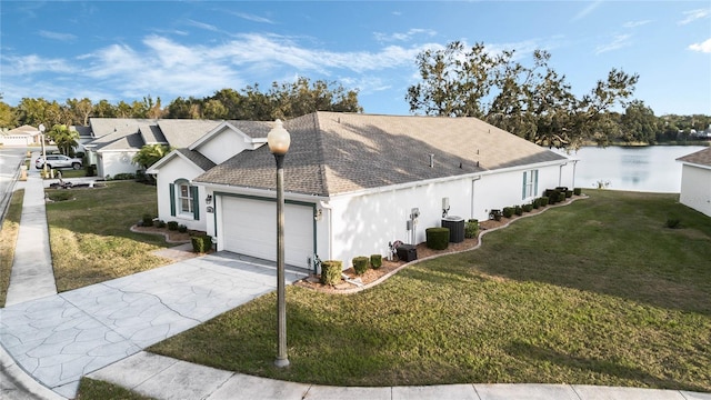 view of side of property with central AC unit, a yard, and a water view