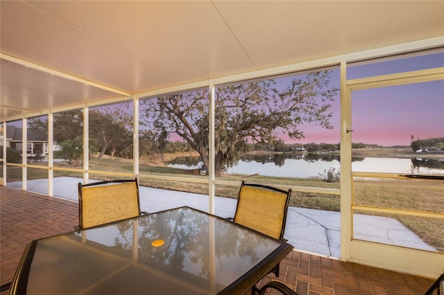 unfurnished sunroom with a water view