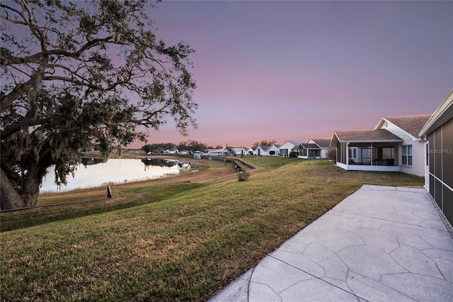 yard at dusk with a water view