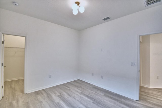 empty room with light hardwood / wood-style floors