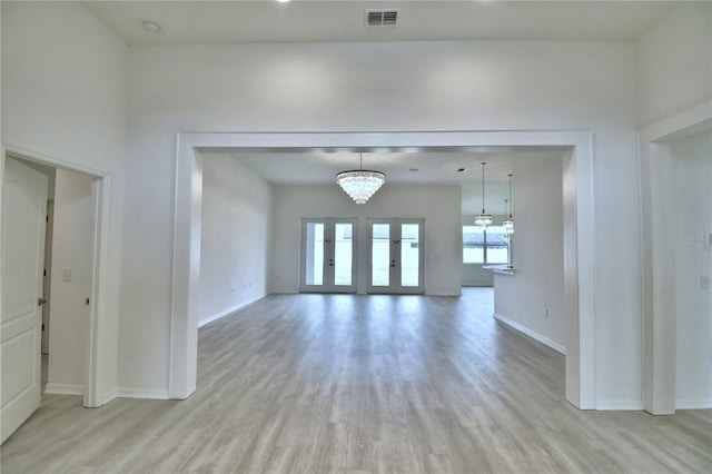 interior space featuring a chandelier and light wood-type flooring