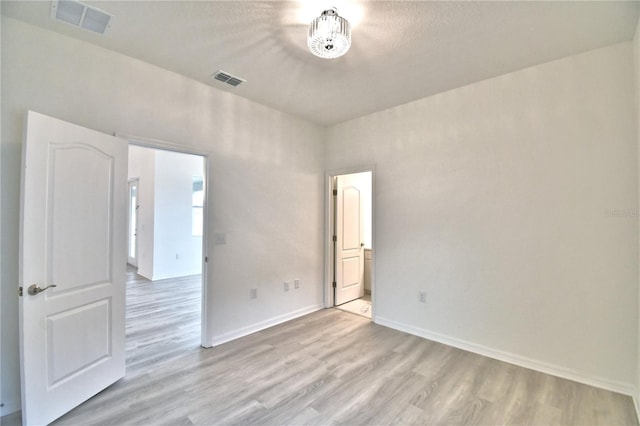 spare room featuring light wood-type flooring