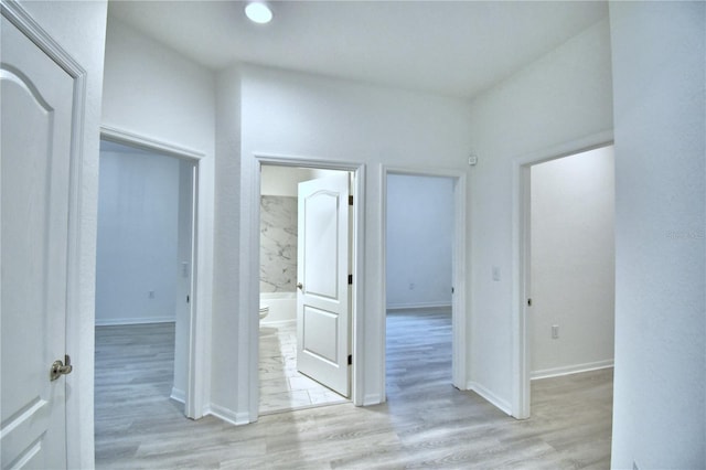 hallway with light hardwood / wood-style flooring