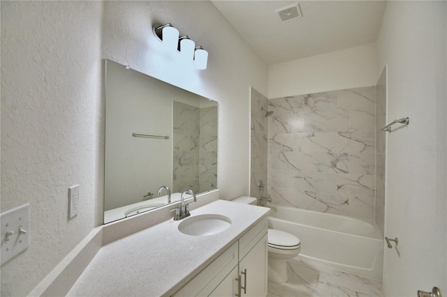 full bathroom featuring vanity, tiled shower / bath combo, and toilet