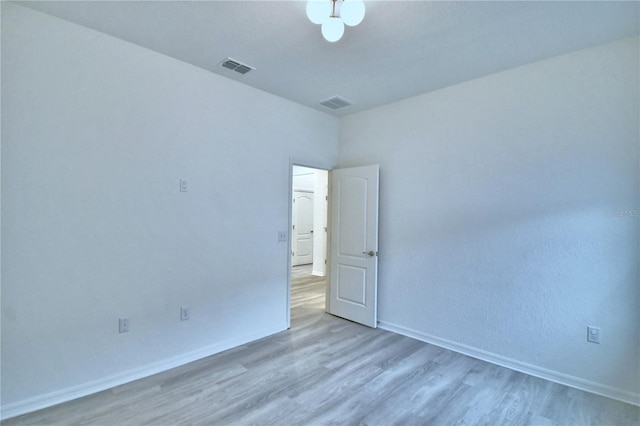 spare room featuring light wood-type flooring