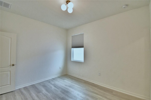 spare room with light hardwood / wood-style flooring