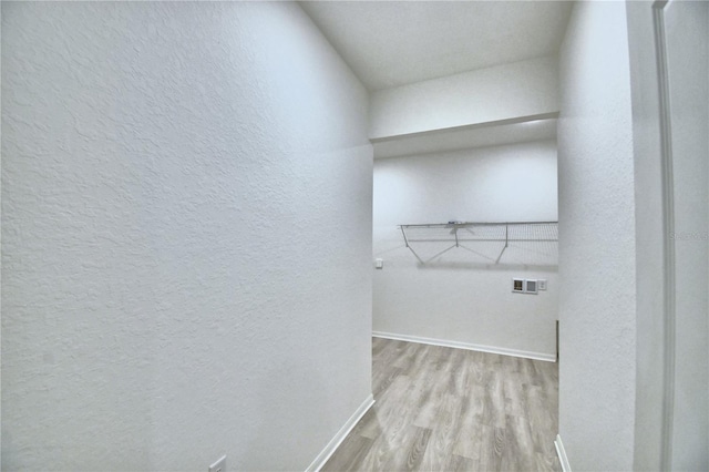 laundry area with washer hookup and light hardwood / wood-style flooring