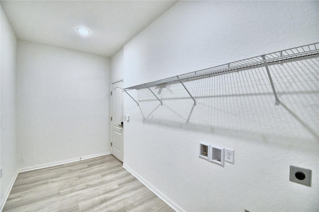 laundry room with electric dryer hookup, washer hookup, and light wood-type flooring