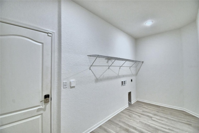 laundry area featuring washer hookup, light hardwood / wood-style flooring, and electric dryer hookup