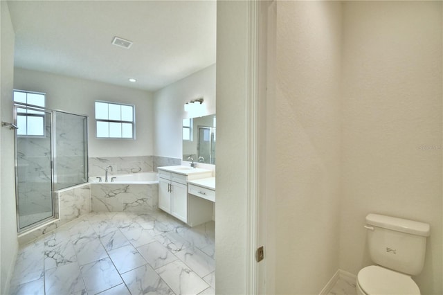 full bathroom featuring vanity, toilet, and separate shower and tub