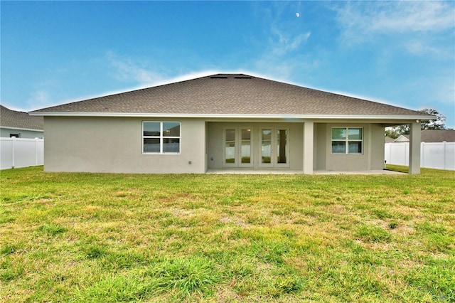 rear view of house featuring a patio and a lawn