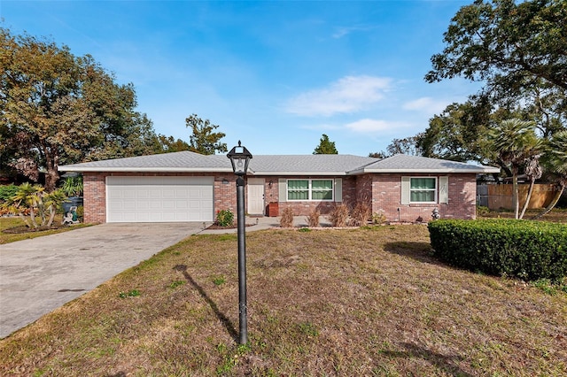 ranch-style home with a garage and a front lawn