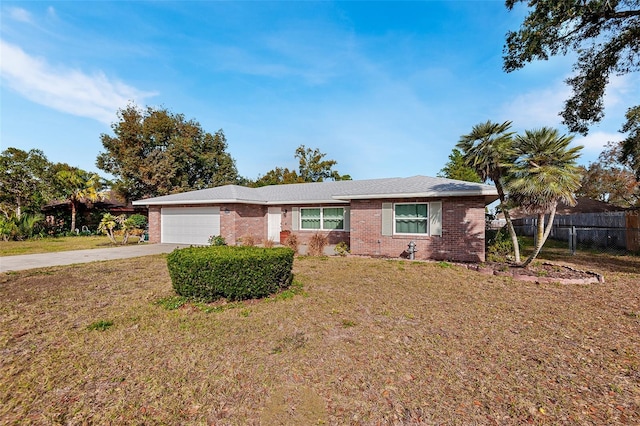 ranch-style home with a garage and a front yard