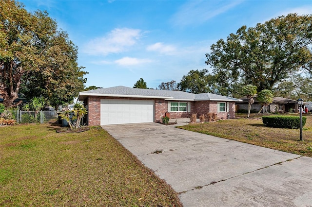 ranch-style home with a garage and a front lawn