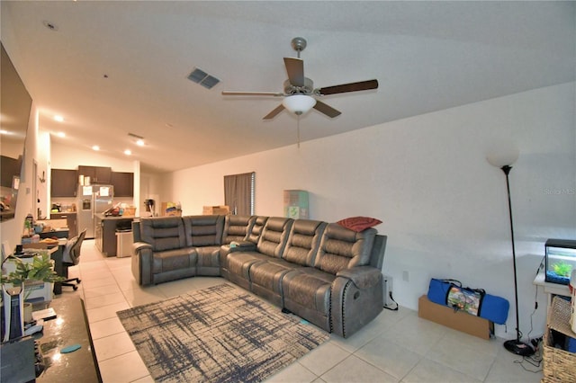 living room with ceiling fan, lofted ceiling, and light tile patterned floors