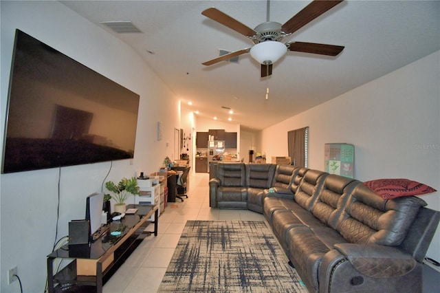 living room with lofted ceiling and light tile patterned floors