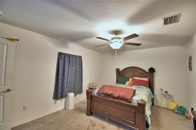 bedroom with light carpet, a textured ceiling, and ceiling fan